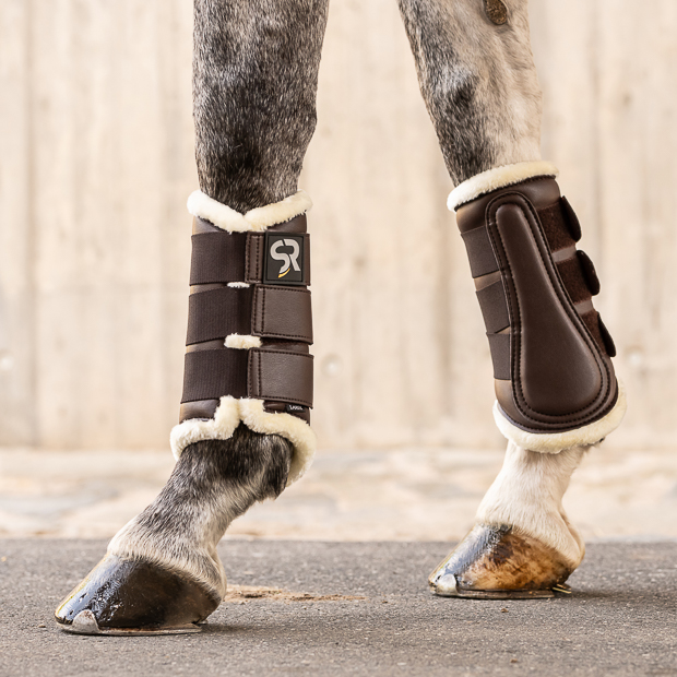 brown dressage leather boots from leather and fur inside with elastic velcro closures on horse leg