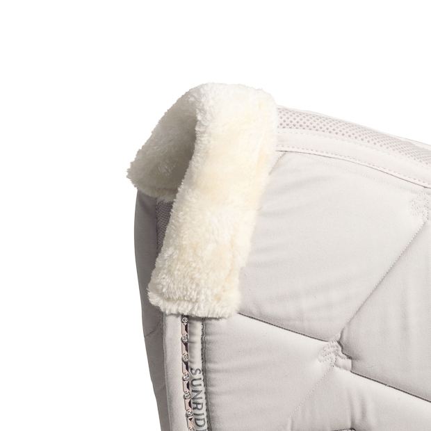 detailed view of fur of breathable dressage saddle pad wellington beige with  gemstones and fur on withers