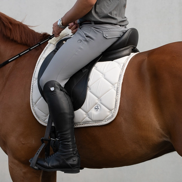 dressage saddle pad wellington beige with gemstones, breathable spine and padded withers on horse breathable dressage saddle pad wellington beige with  gemstones and fur on withers under saddle on a horse