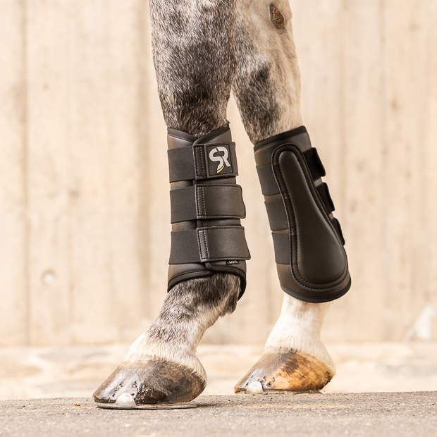 leather and neoprene dressage boots black on horse black dressage leather boots from leather and neoprene inside with elastic velcro closures on horse leg