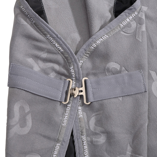 detailed view of front closure of grey cooler rug with removable belly straps wellington line by sunride