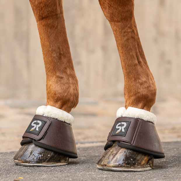 bell boots brown leather with fur on horse brown leather bell boots with fur and  neoprene inside and velcro closure on a horse