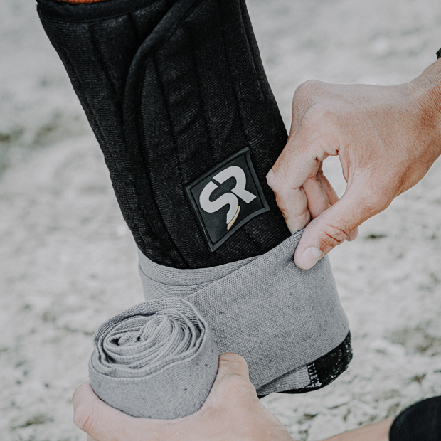 bandaging pads black with velcro cosure on horse leg black bandaging pads with sr logo and velcro closure on horse