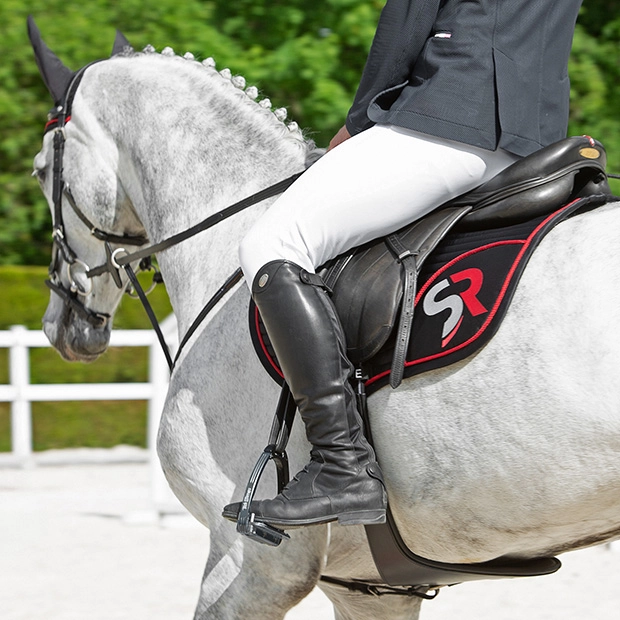 black red sr line jumping saddle pad with breathable air mesh spine by sunride under a saddle on a horse with rider