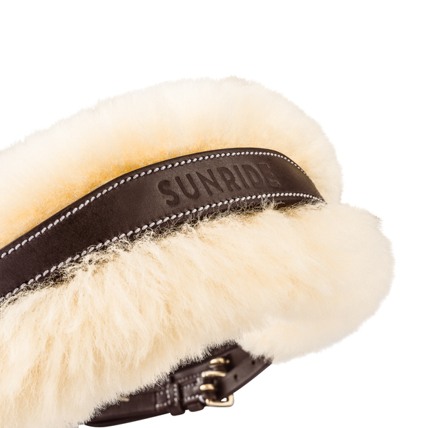 padded neck part of brown swedish leather bridle with fur padding oxford including reins detailed view of padded and shaped neck part of brown swedish leather bridle oxford with golden mounting and fur padding including reins by sunride