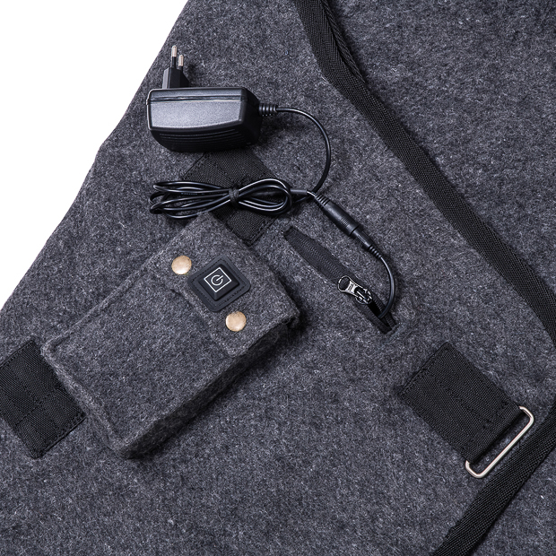 battery and connection to charger inside battery pocket of grey heating rug st. moritz from wool detailed view of battery pocket and battery connection to charger of grey wool heating rug st. moritz with three levels of heating and program