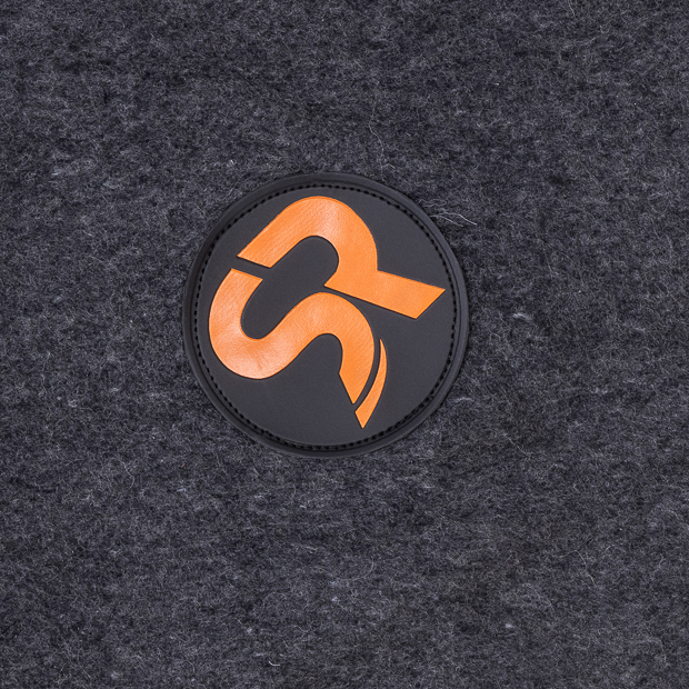 sr logo of grey heating rug st. moritz from wool detailed view of sr logo of grey wool heating rug st. moritz with three levels of heating and program