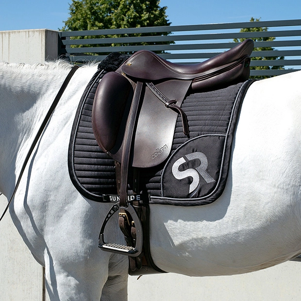 dressage saddle pad silver black breathable with fur on horse sr embroidery of breathable dressage saddle pad silver and black exclusive line with fur on withers under saddle on a horse
